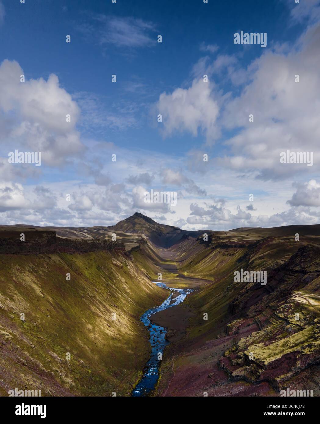 Aerial view of a glacial river winding through a rugged canyon, cutting ...
