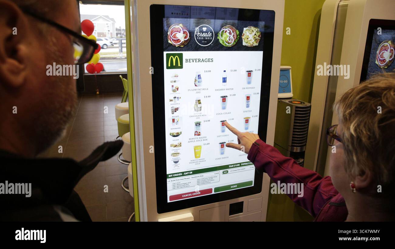 December 16, 2014 - Downers Grove, IL, USA - Customers use the Create Your Taste self-ordering kiosk in the McDonald's on the 2500 block of Ogden Avenue on Dec. 16, 2014 in Downers Grove, Ill. This McDonald's is a test site for the new self-ordering kiosk. The kiosk allows customers to their order including the toppings, size, and sides. (Credit Image: © Stacey Wescott/TNS via ZUMA Wire) Stock Photo