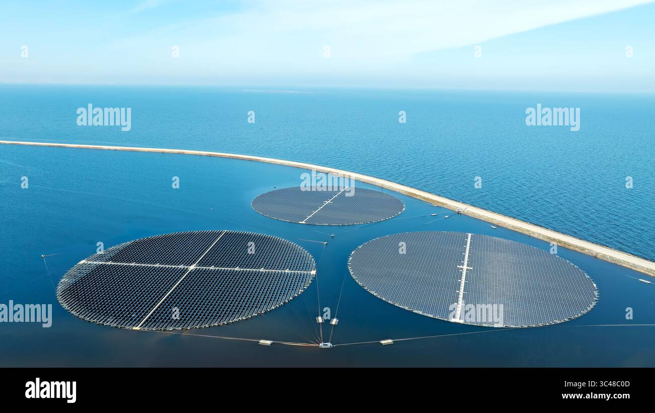 Round solar panels float on the water in the storage basins at Andijk in the Netherlands. Stock Photo