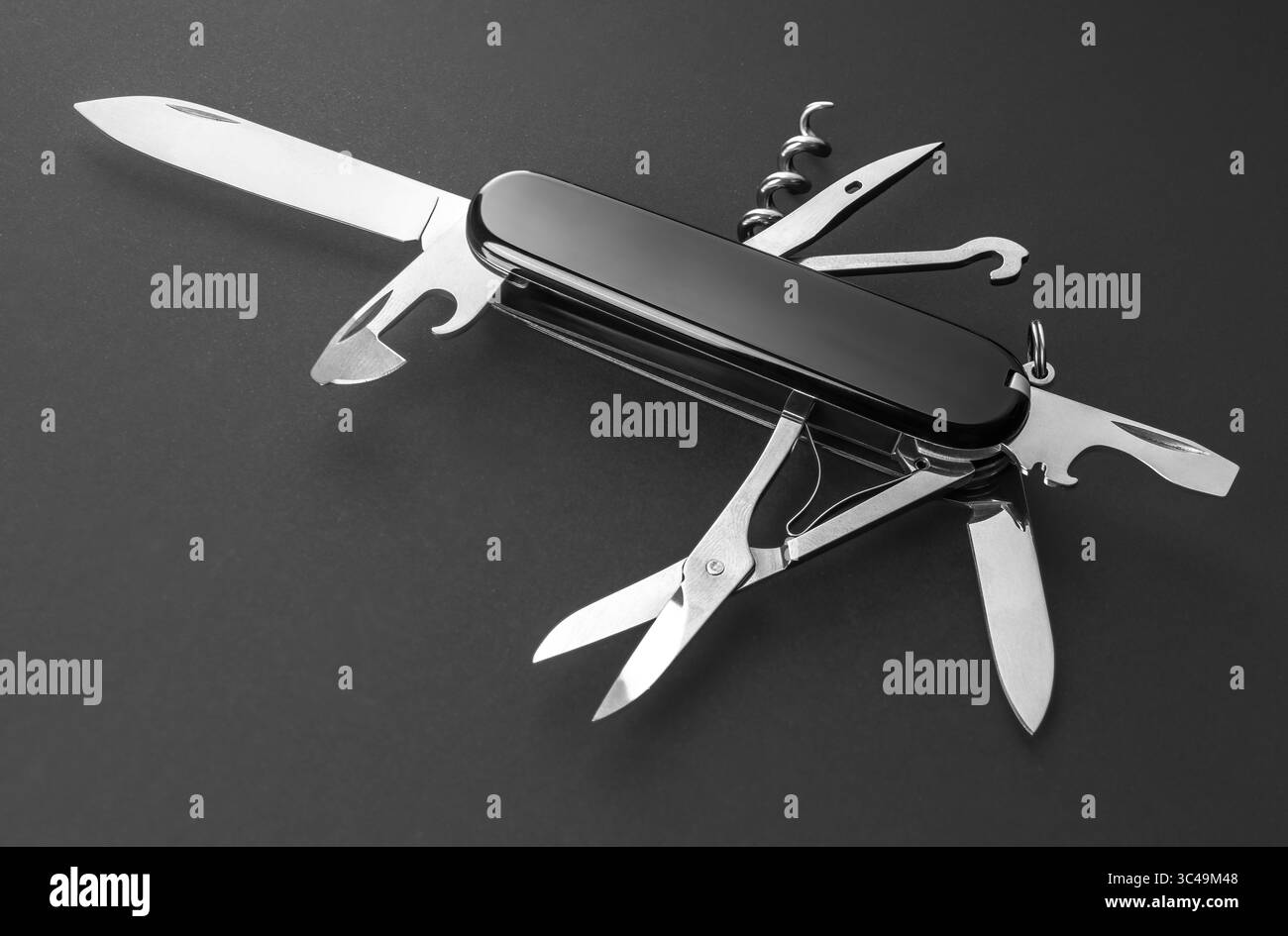 Multifunction army pocket folding knife isolated on black background Stock Photo