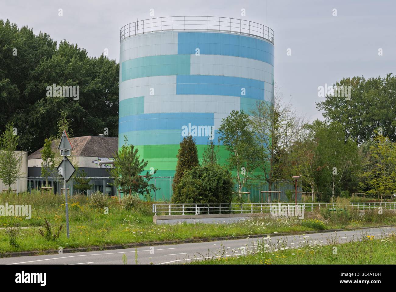 Heat buffer Nieuwegein, Utrecht. The boiler is painted in camouflage colors of white, blue, and green to blend in with the streetscape. Stock Photo