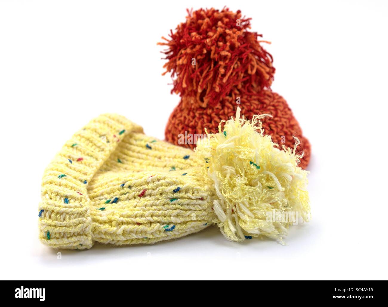 Two bobble hats against a white background Stock Photo