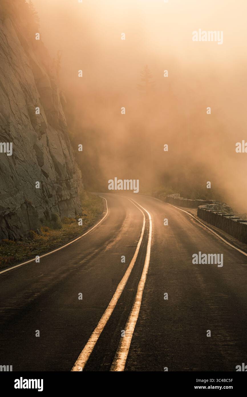 Misty conditions obscure views along a cliffside drive in Mount Rainier ...