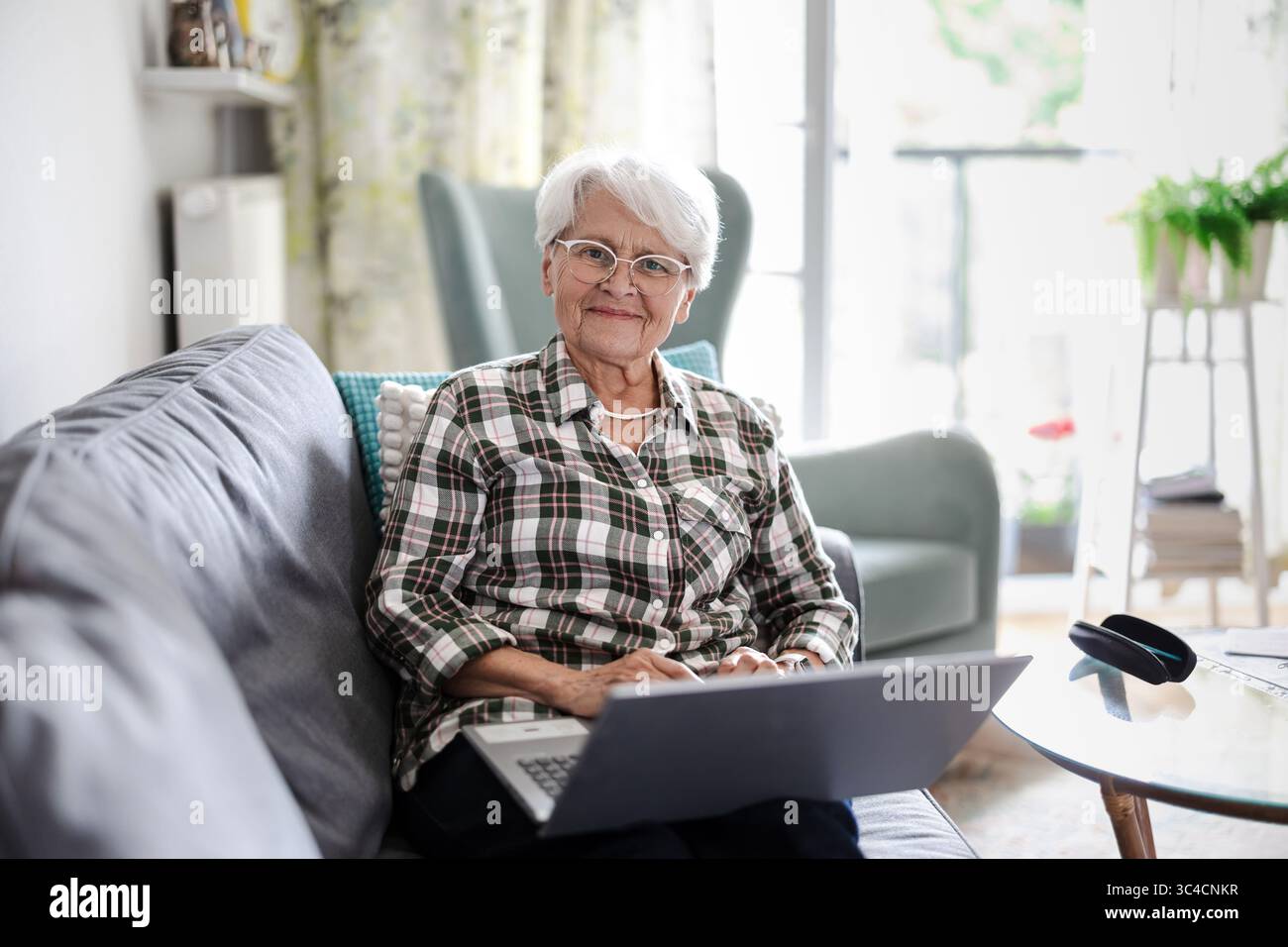 Senior woman using laptop at home Stock Photo