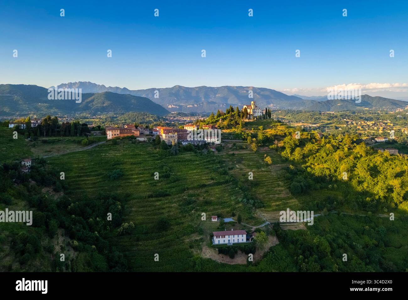 View of Santuario della Beata Vergine del Carmelo at the top of a hill at sunset in summer. Montevecchia, Lecco district, Lombardy, Italy. Stock Photo
