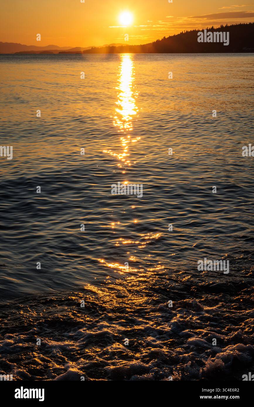 Moments before sunset over the Pacific Ocean on a beach in British Columbia, Canada. Stock Photo