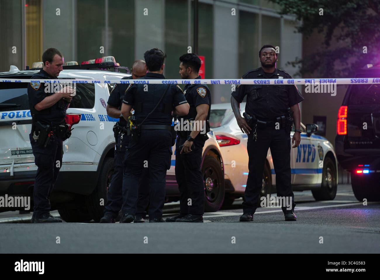 A New York Police officers gather at the scene on 52nd Street outside a ...