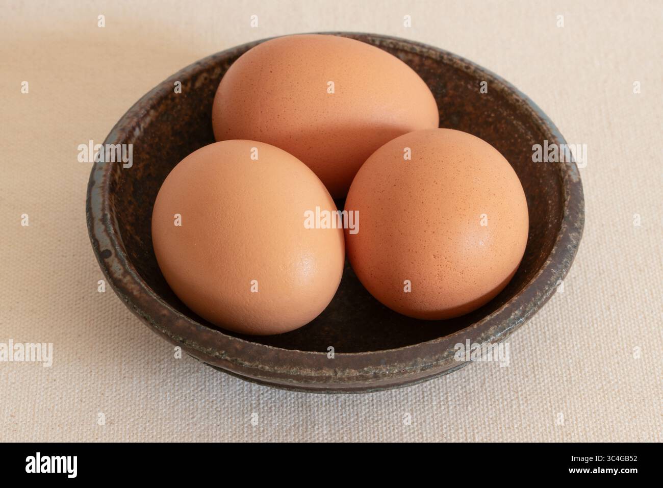 Three Brown Pasture Raised Chicken Eggs Stock Photo