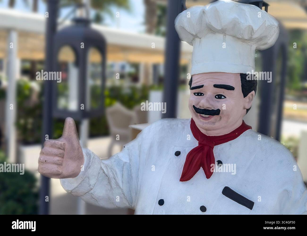 Figurine of a chef outside a restaurant Stock Photo