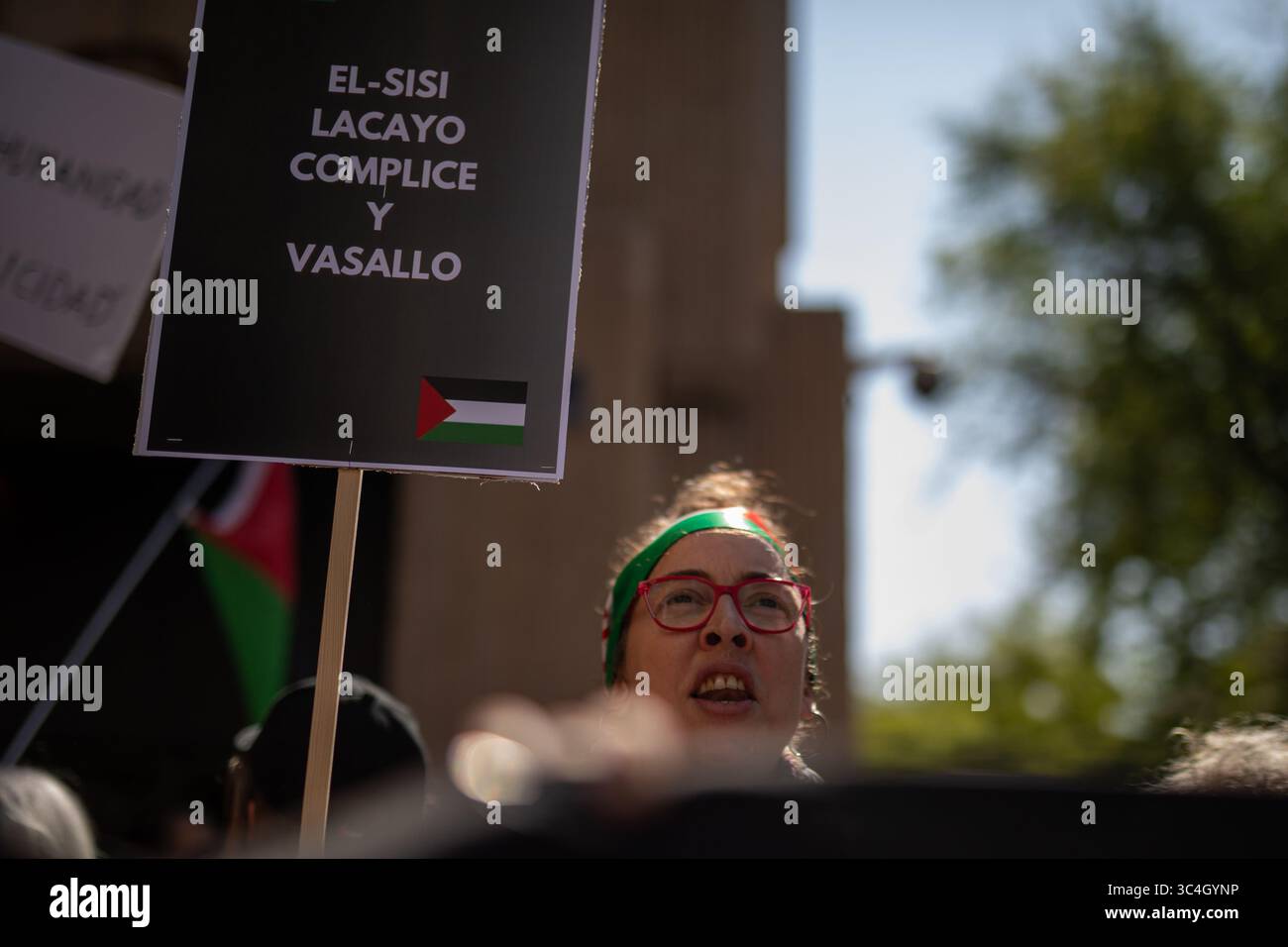 A protestor carries a sign during a demonstration demanding the opening ...