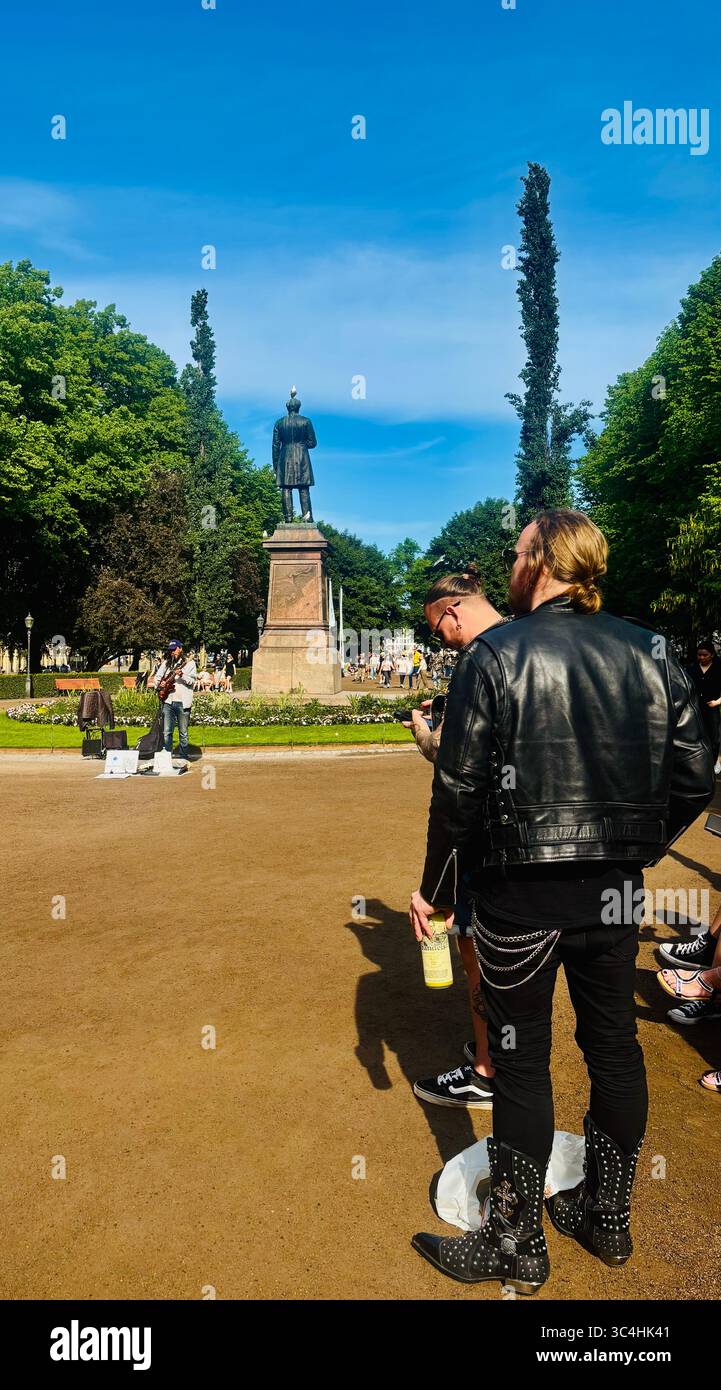 Iron Maiden fans by the Statue of Johan Ludvig Runeberg in the Esplanadi park in Helsinki, Finland. - Smartphone Captured Stock Image