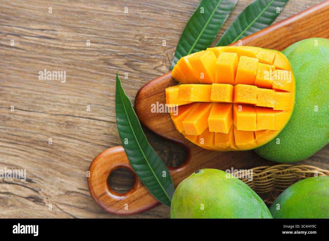 Top view of a juicy ripe mango sliced in a grid pattern and partially ...