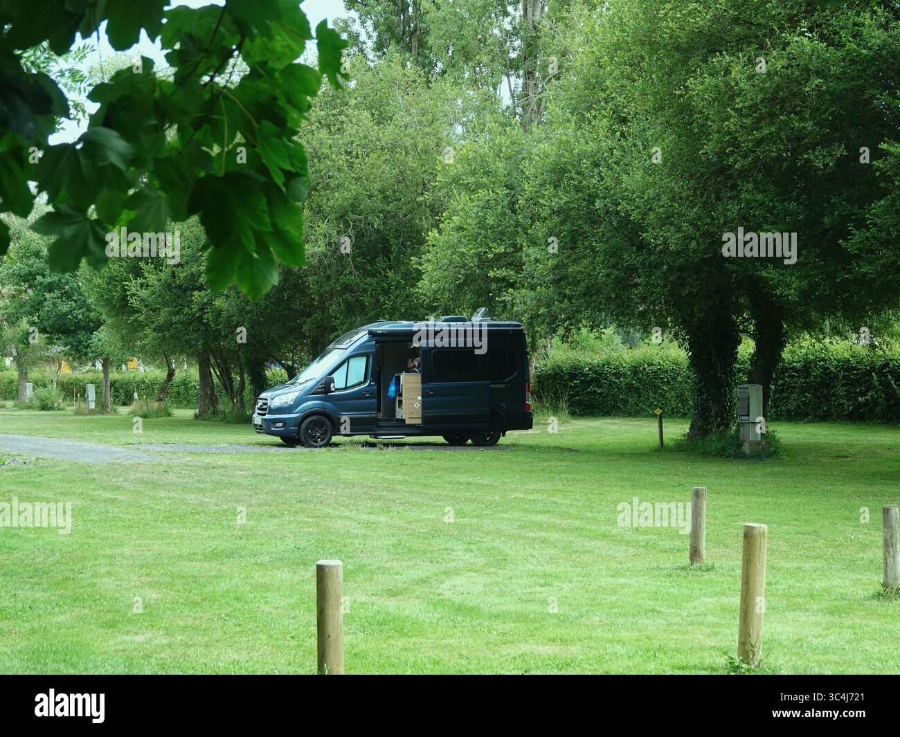 Camper Van Parked in Scenic Countryside Surrounded by Lush Green Trees ...