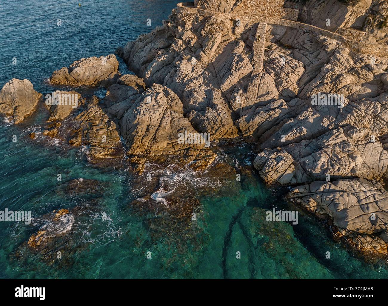 Turkish Riviera Rugged Rocks Beach Aerial view of rugged rocks meeting the turquoise sea, a dance of rough ...
