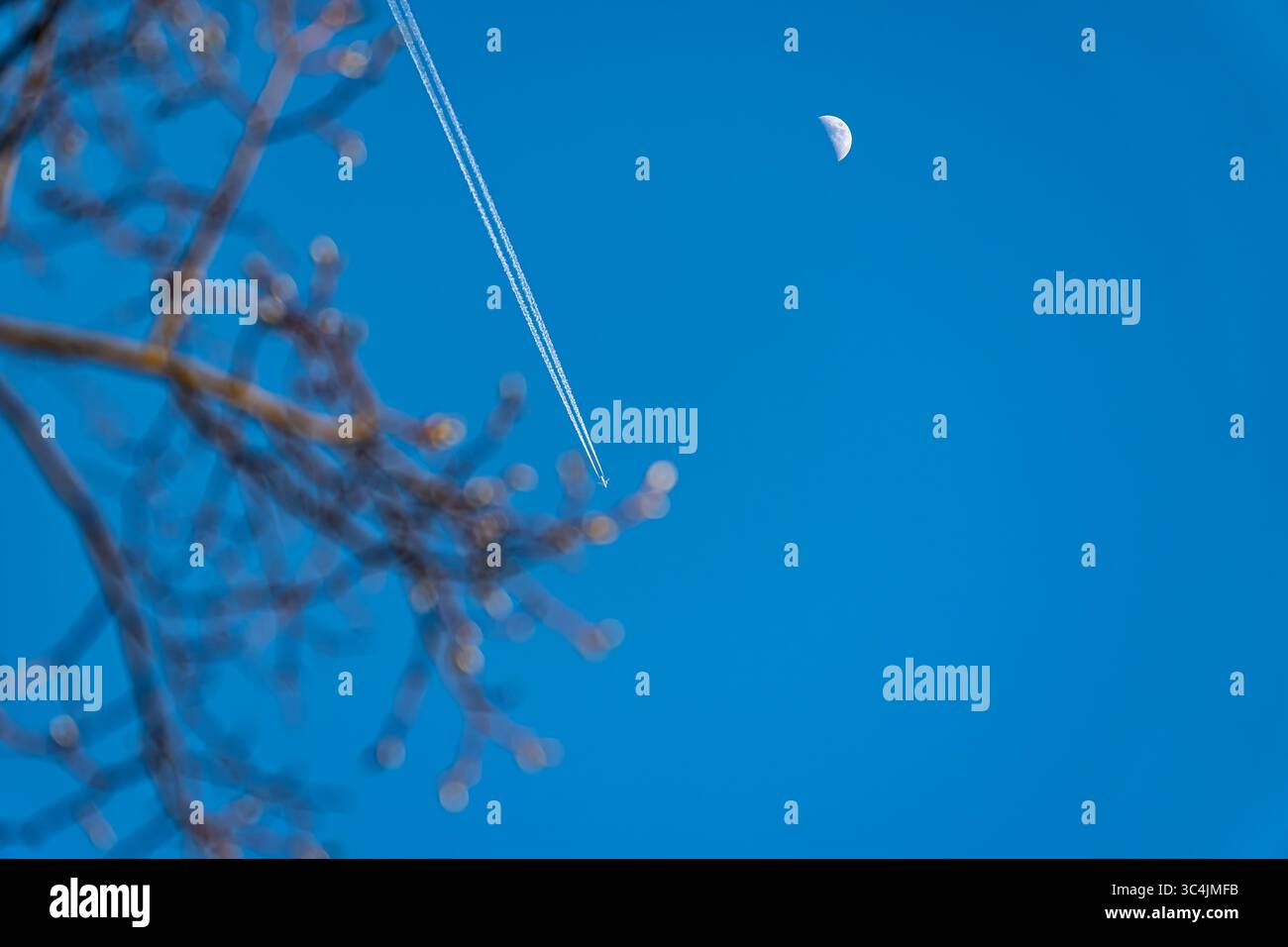 Airplane crosses sky on spring hi-res stock photography and images - Alamy