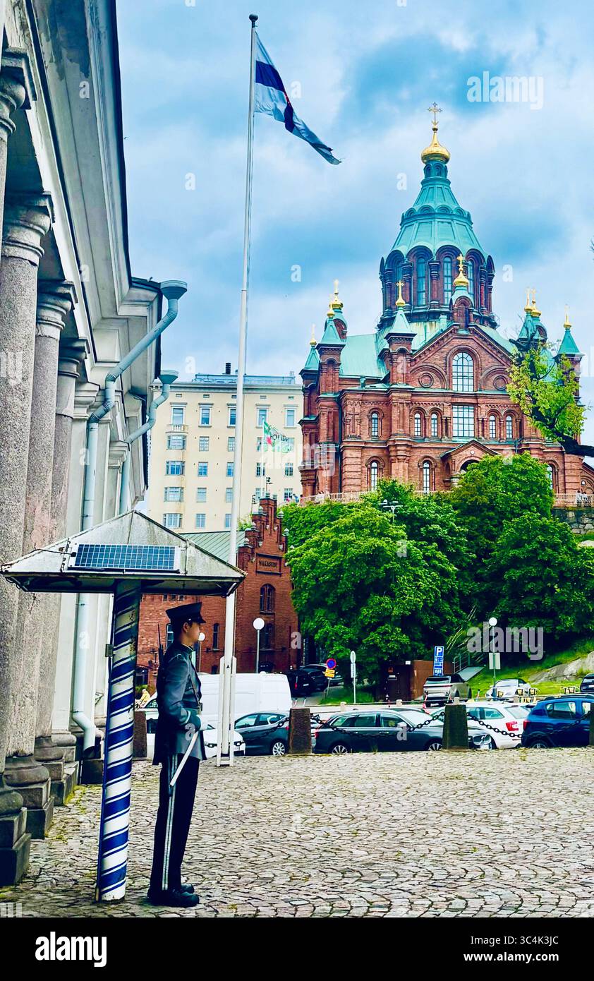 A guard standng outside the house of the Main Guard situated next to the Presidential Palace in Helsinki, Finland. - Smartphone Captured Stock Image