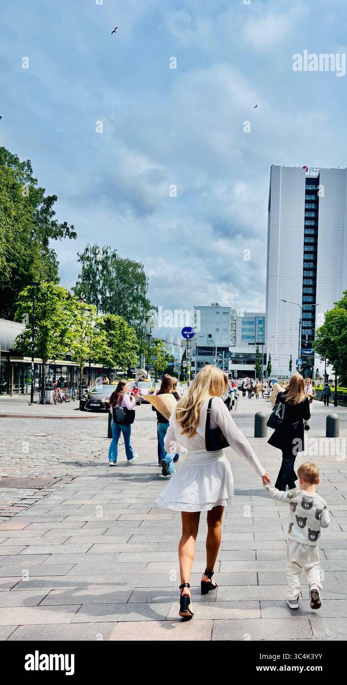 An Estonian woman holding hands with her child. Photo taken in Tallinn, Estonia. - Smartphone Captured Stock Image
