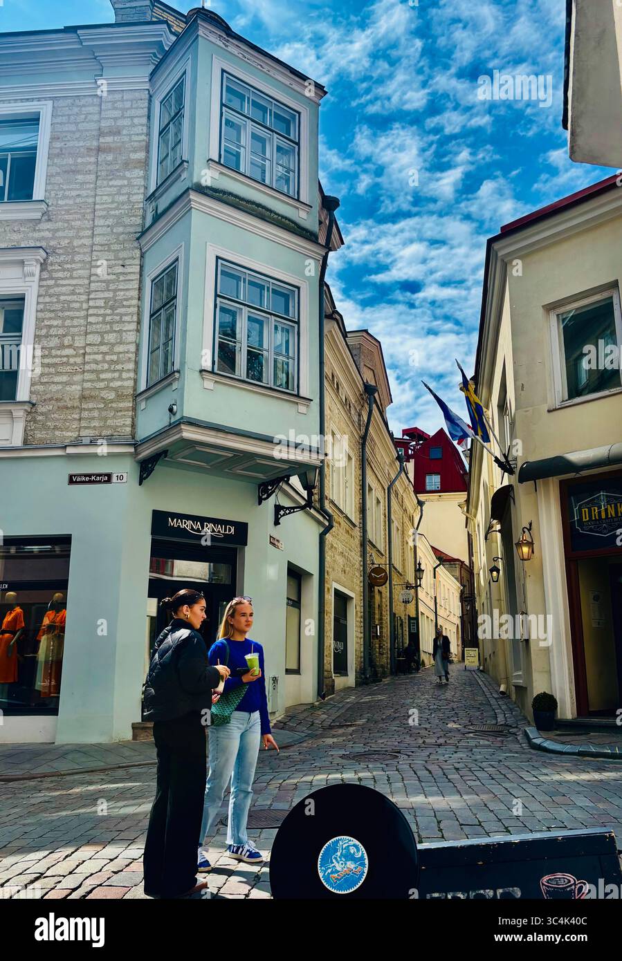 Young women standing on Müürivahe street in Tallinn, Estonia. - Smartphone Captured Stock Image