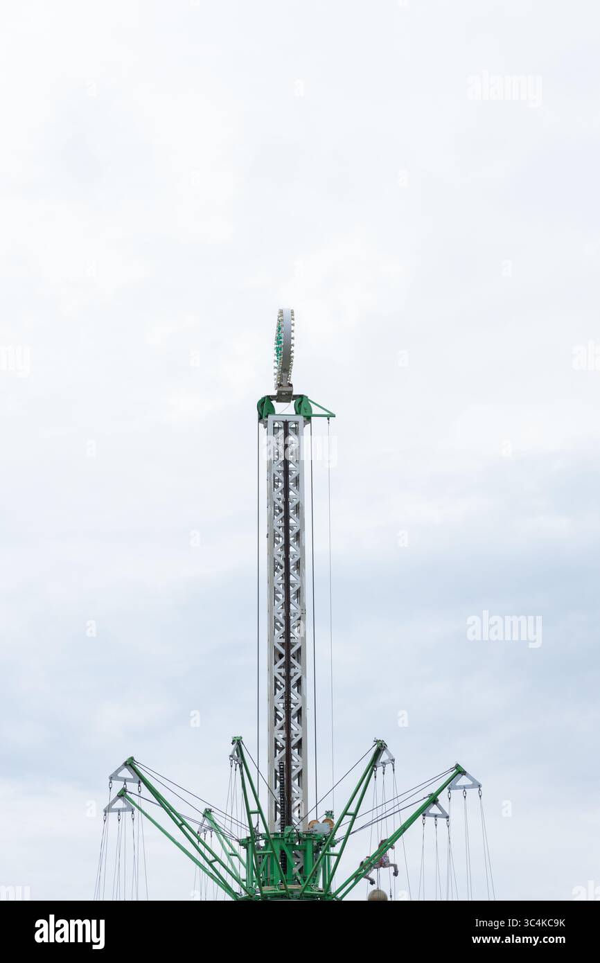 Exciting View of a Tall Amusement Park Ride Against a Cloudy Sky ...