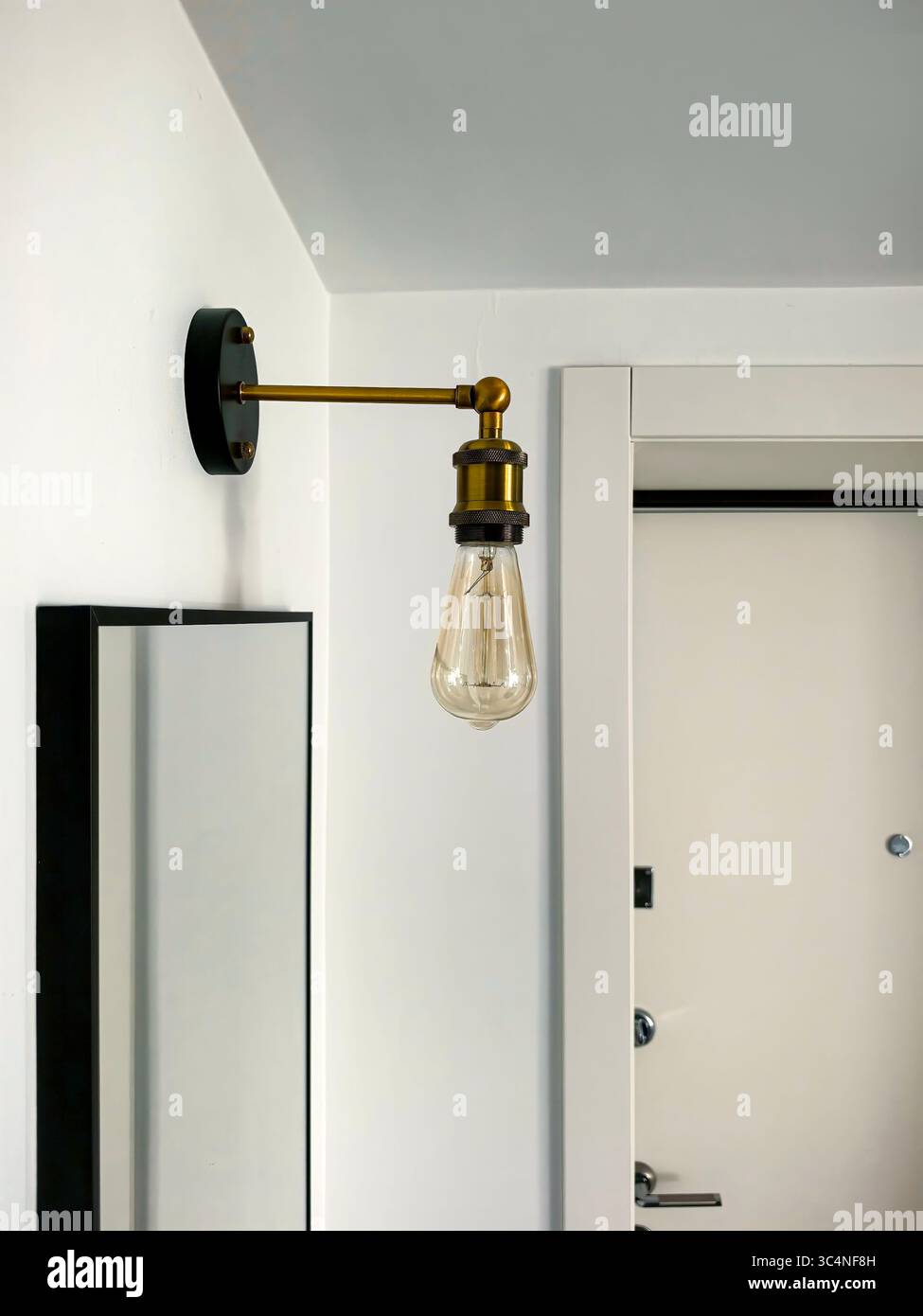 Wall-mounted light fixture with a vintage bulb design in a modern ...
