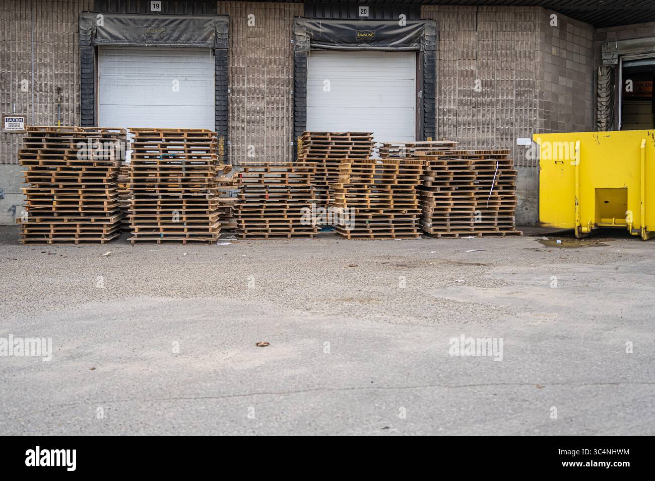 Stack of Wood pallets in front of loading dock Stock Photo - Alamy