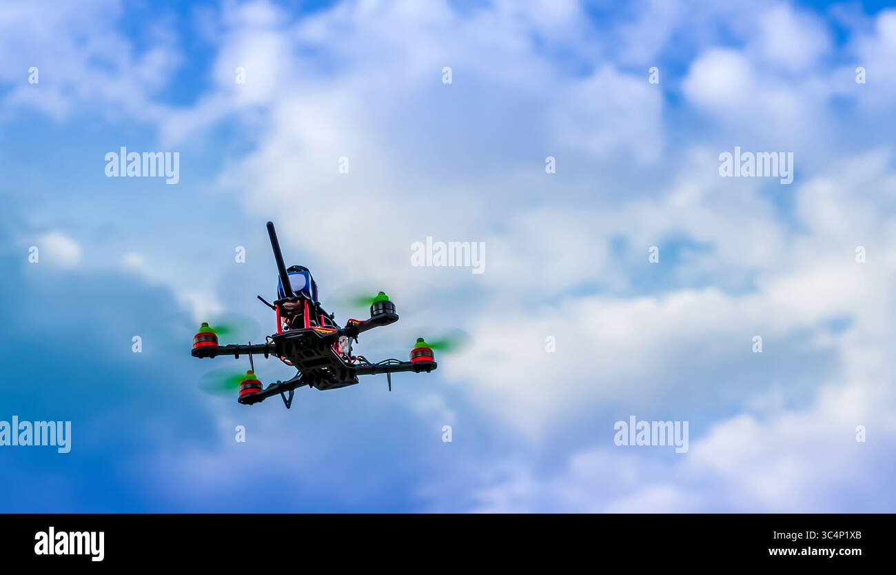 flying DIY drone against the blue cloudy sky Stock Photo