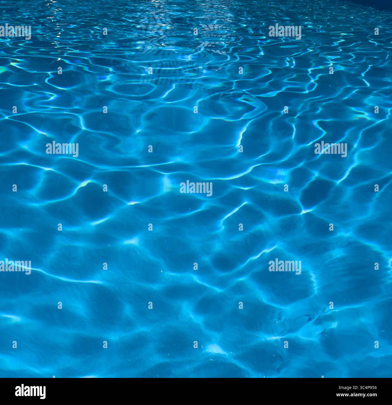 Clear blue water with sunlit ripples Stock Photo
