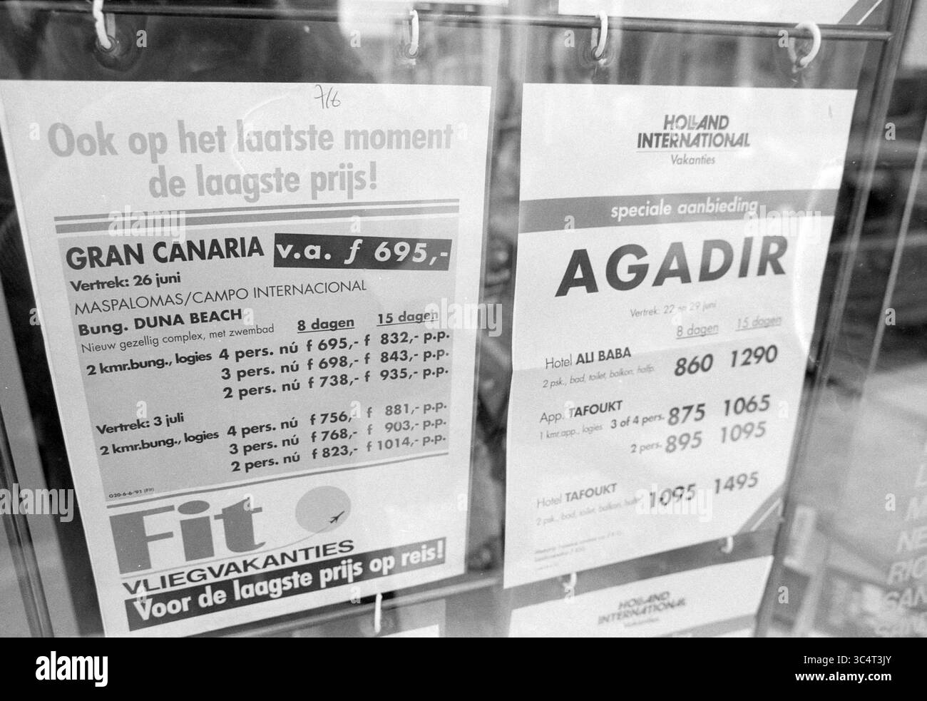 Posters with last minute holiday offers, 12-06-1991 Whizgle News, Dutch Desk, The Netherlands, 1950-2000 A display board featuring vacation package details, prominently showcasing offers for Gran Canaria and Agadir, including prices and travel dates. Each listing highlights various accommodations and their corresponding costs, encouraging travelers to book their trips. Stock Photo