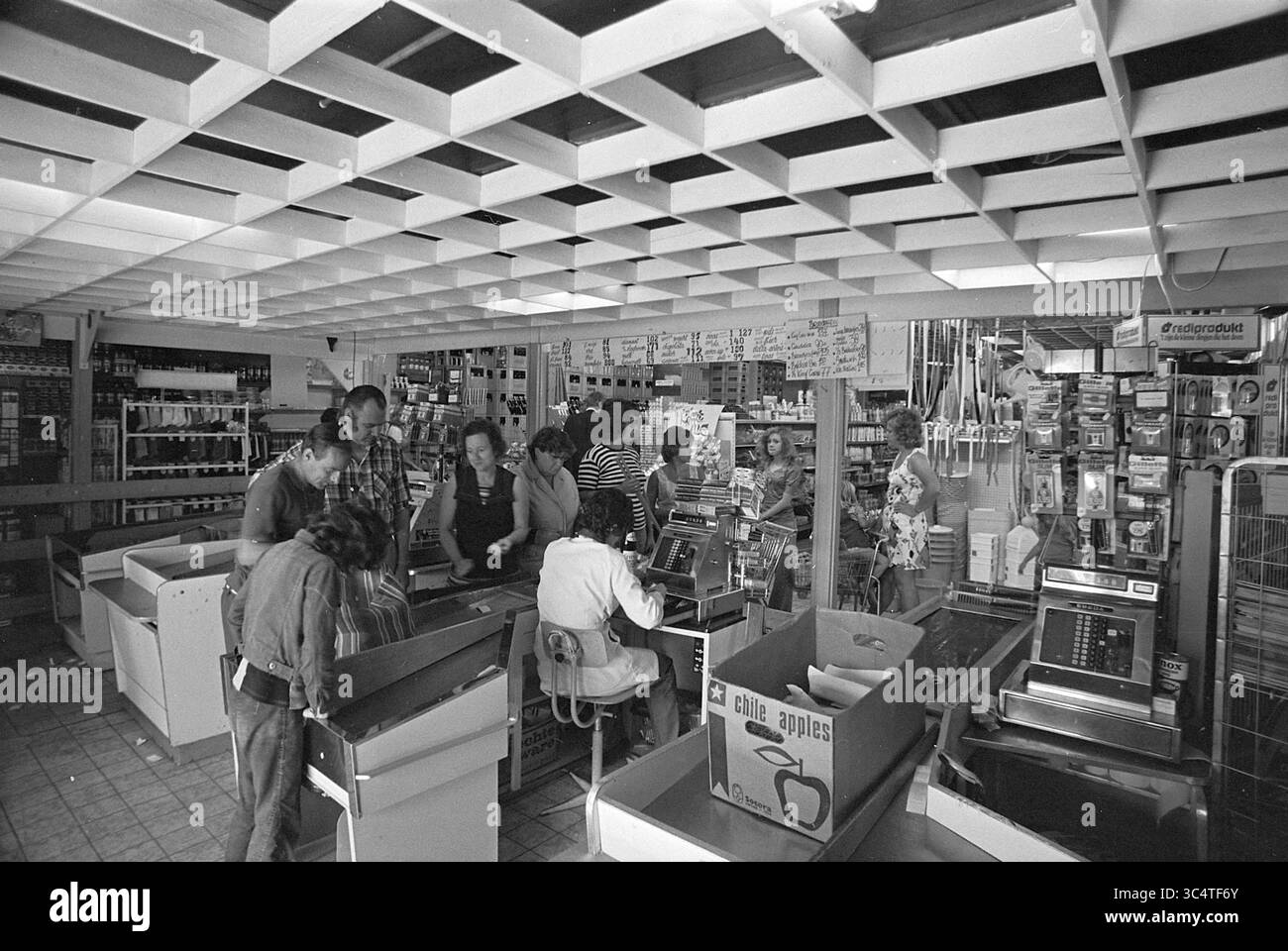 Duinrell camping in Wassenaar, Kampen, campsites, camp site, camping, camping hut, Tourism, tourists, 26-07-1974 Whizgle News, Dutch Desk, The Netherlands, 1950-2000 A bustling grocery store scene captures customers and employees engaged in various activities, with cash registers in action and shelves stocked with products. The space is filled with people interacting, creating a lively atmosphere reminiscent of community shopping experiences. Stock Photo