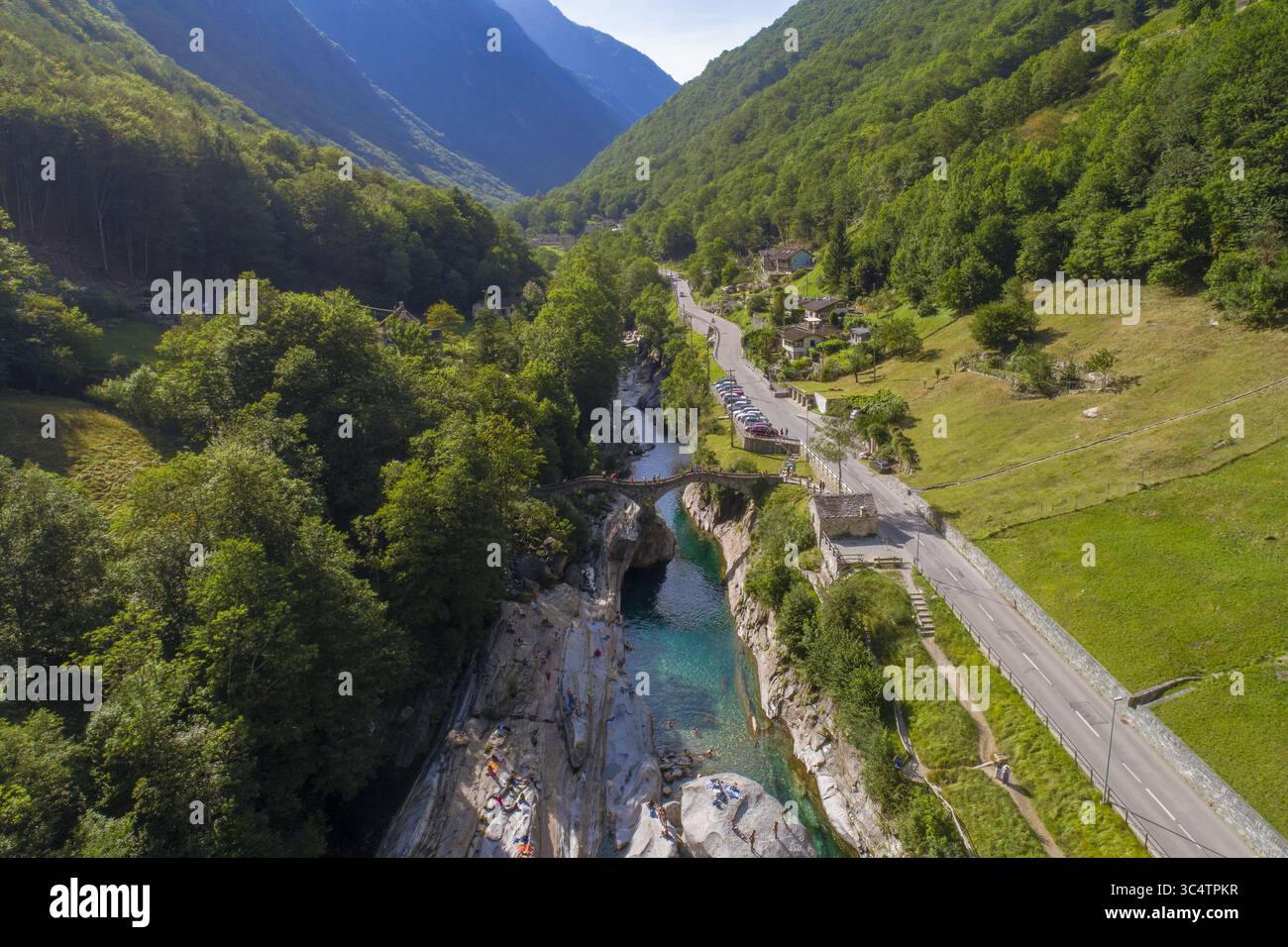 Aerial view of the vibrant Verzasca River carving through the rugged ...