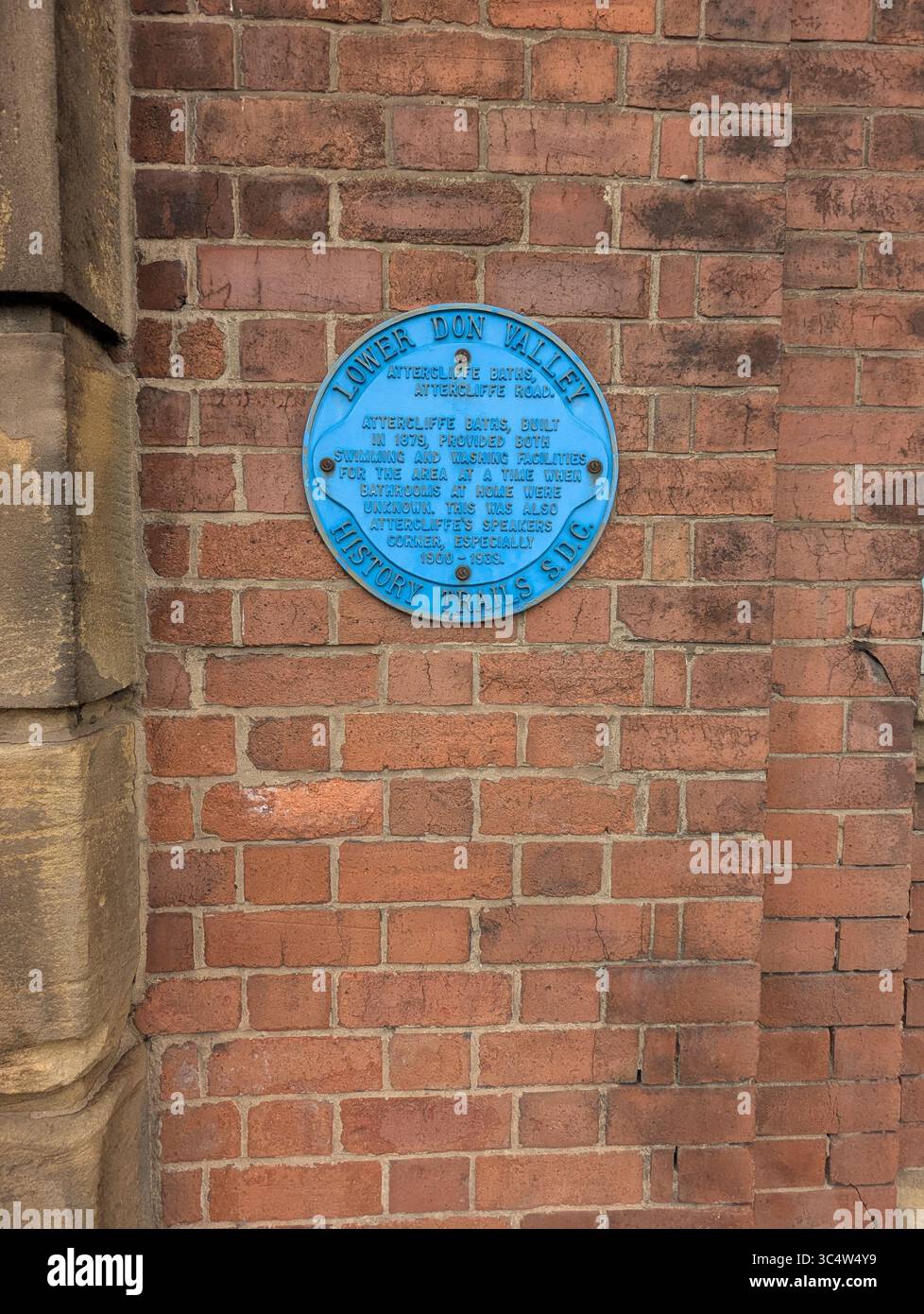 A commemorative Blue Plaque on the wall of the former Attercliffe Baths in Sheffield, UK, previously a swimming and washing facility (built 1879). - Smartphone Captured Stock Image
