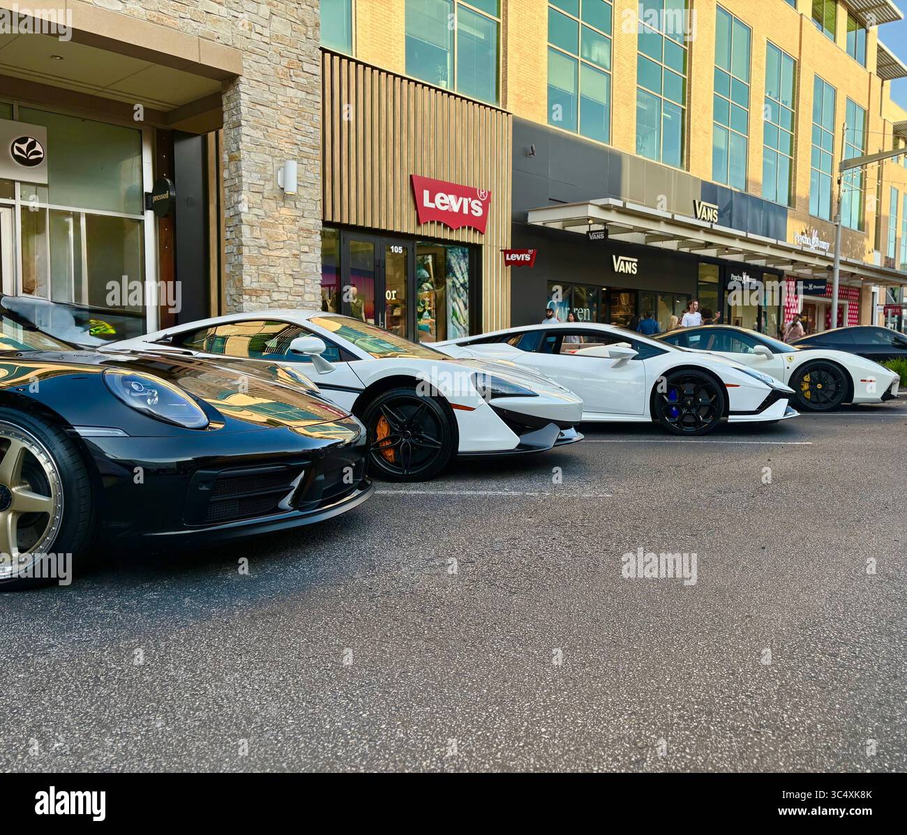 Black Porsche 911, Mclaren 570s, Lamborghini Revuelto, and Ferrari - Smartphone Captured Stock Image Black Porsche 911, Mclaren 570s, Lamborghini Revuelto, and Ferrari - Smartphone Captured Stock Image