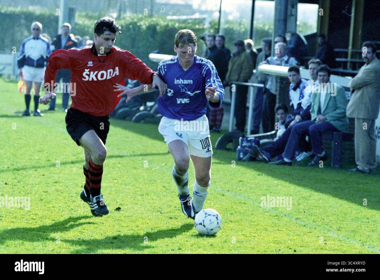 Football: Stormvogels - Quick, 13-03-1999 Whizgle News, Dutch Desk, The Netherlands, 1950-2000 A player in a blue jersey dribbles the football while being closely pursued by an opponent in a red and black kit, with a crowd watching intently from the sidelines. Stock Photo