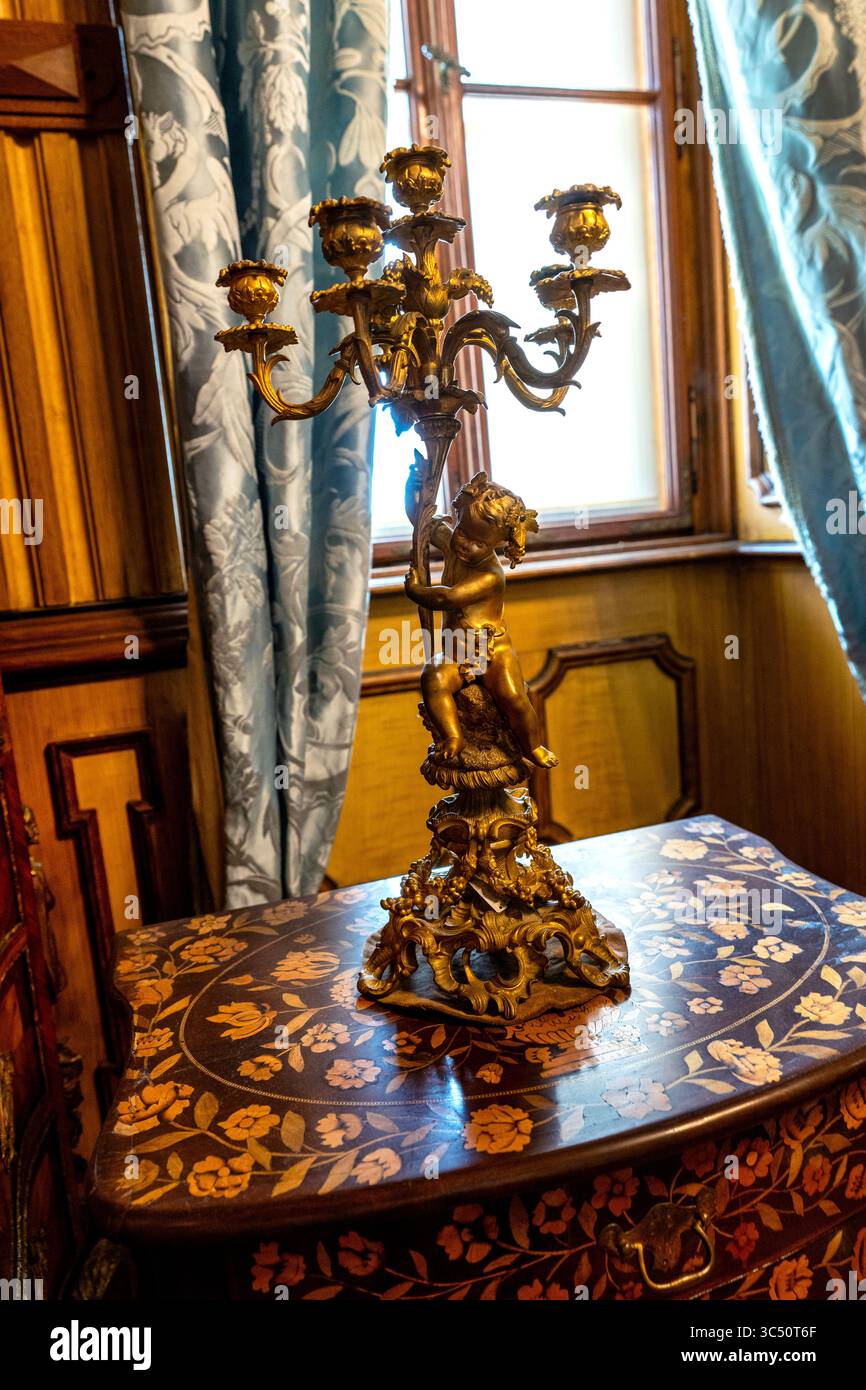 Rococo style gilt bronze candelabra on an in-laid table at Eclectic style Miramare Castle in Trieste, Italy. Stock Photo
