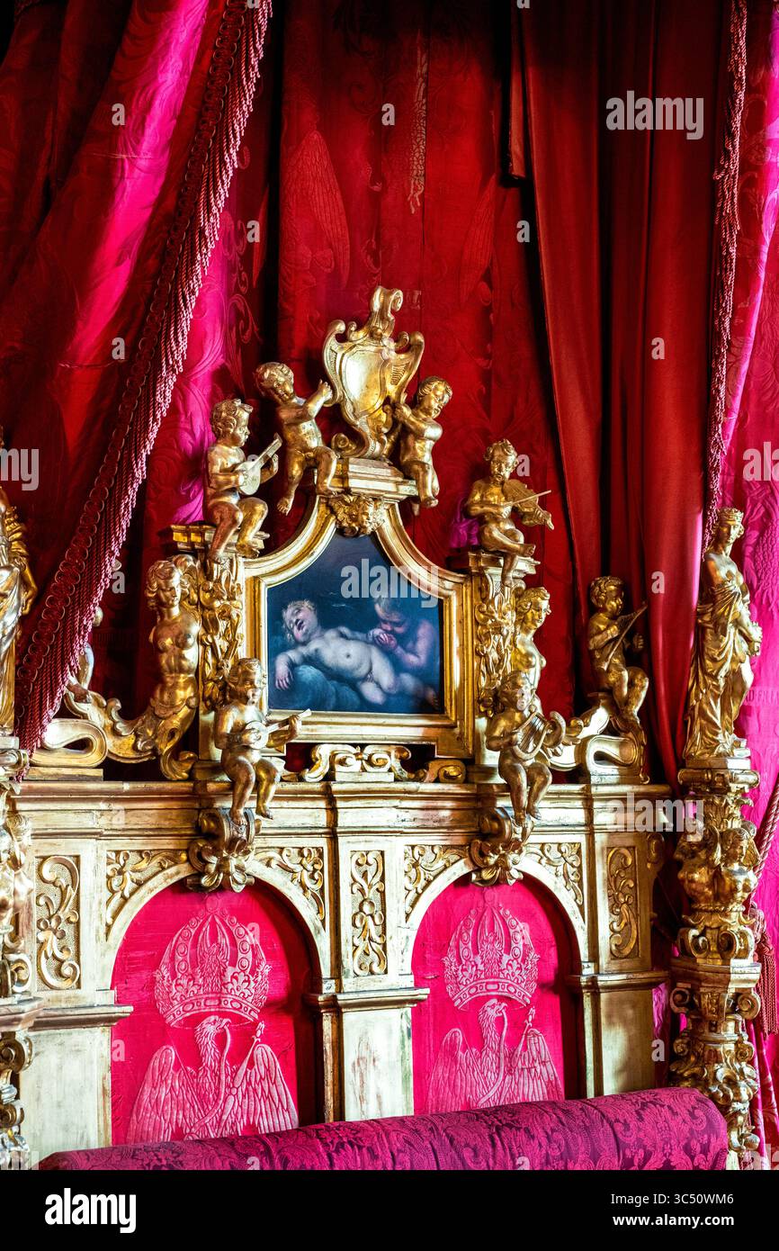 Elaborate bedchamber headboard of Maximillian's bed, a wedding gift from Pope Pius IX, at Miramare Castle in Trieste, Italy. Stock Photo