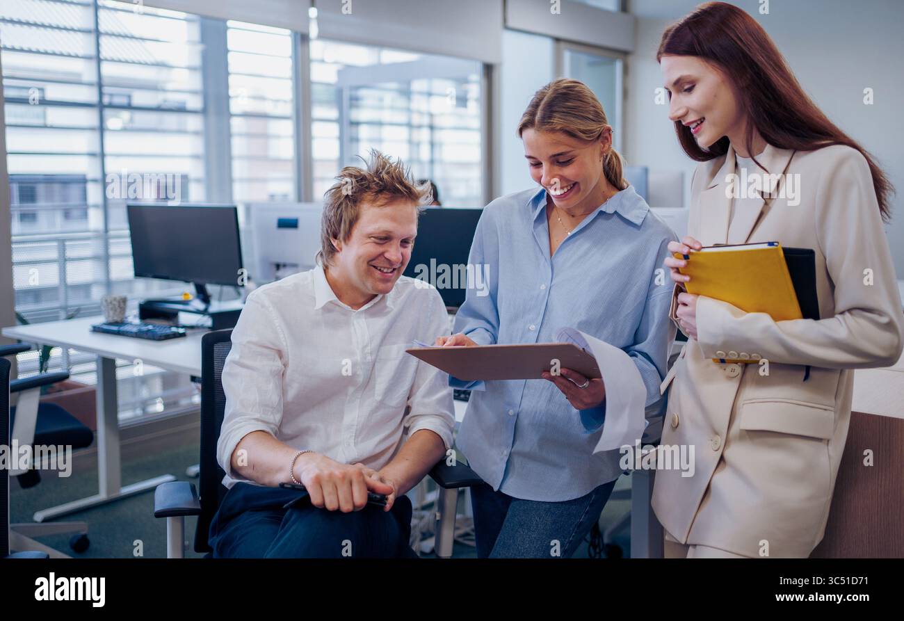 Engaging in a Collaborative Team Discussion within a Modern Office Setting for Enhanced Performance Stock Photo
