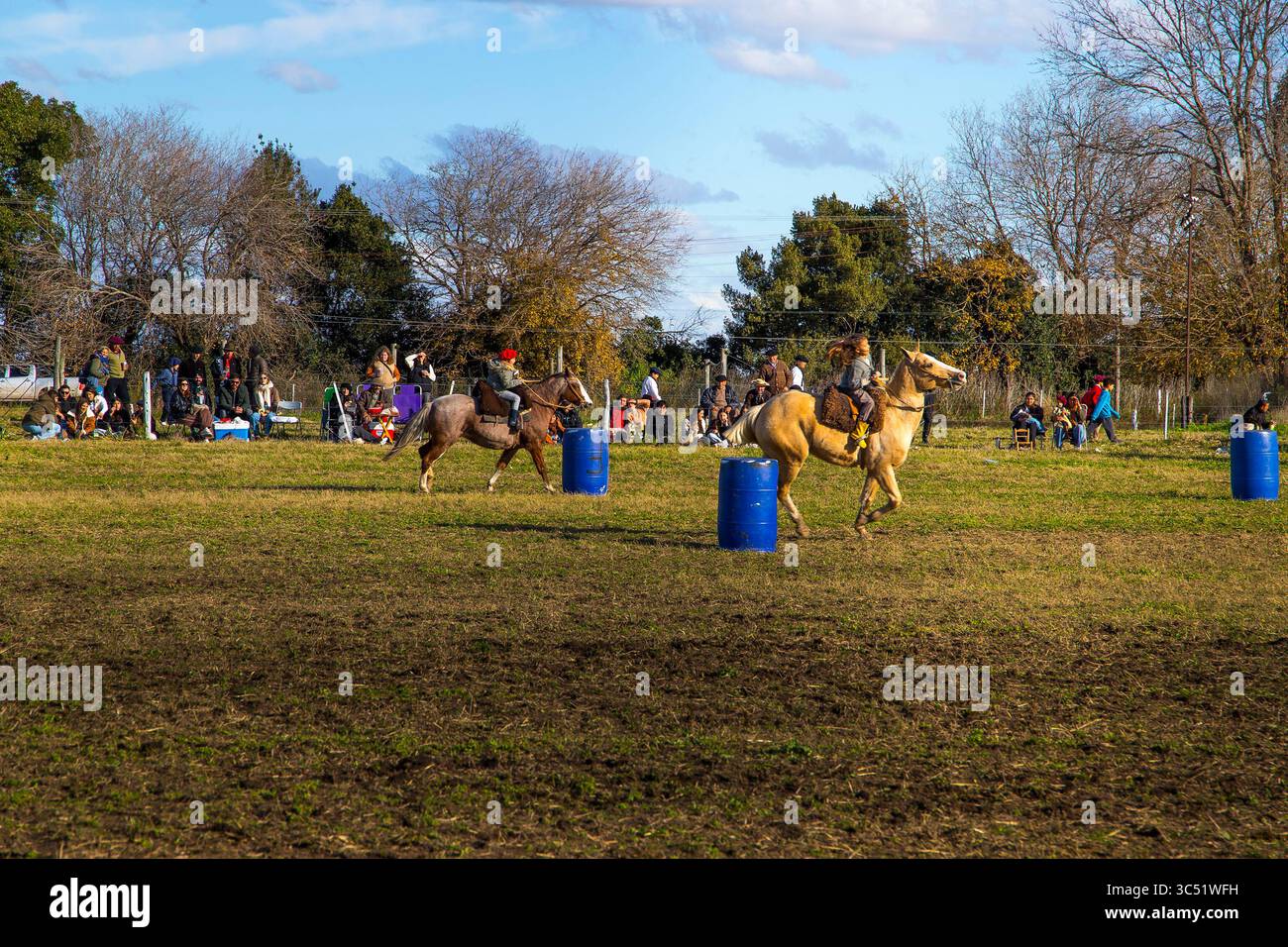 Traditional horse gathering at a rural fair in Argentina, where gauchos skillfully manage herds during a cultural celebration of equestrian heritage. Stock Photo