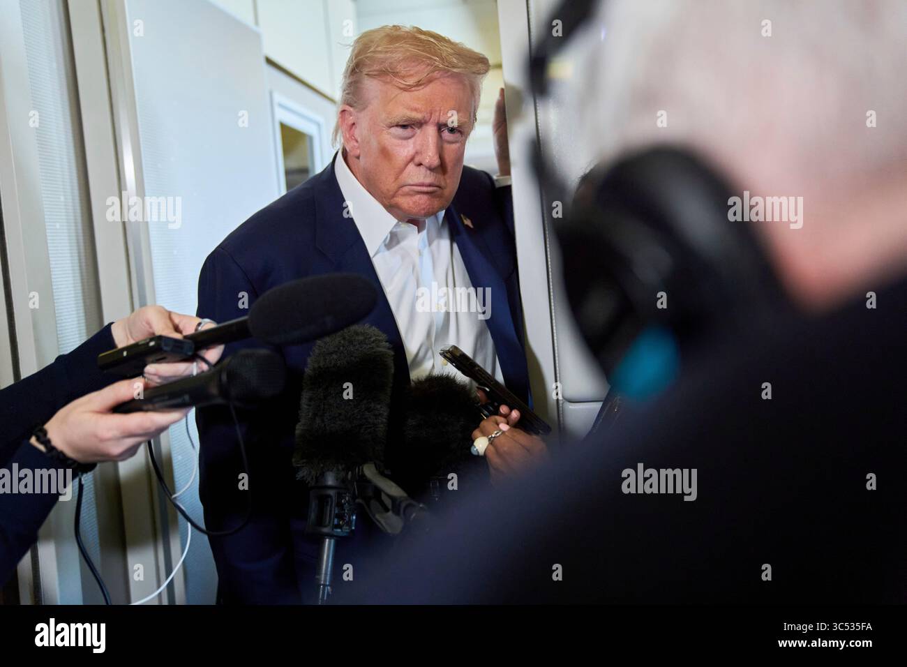 President Donald Trump speaks with reporters aboard Air Force One after ...