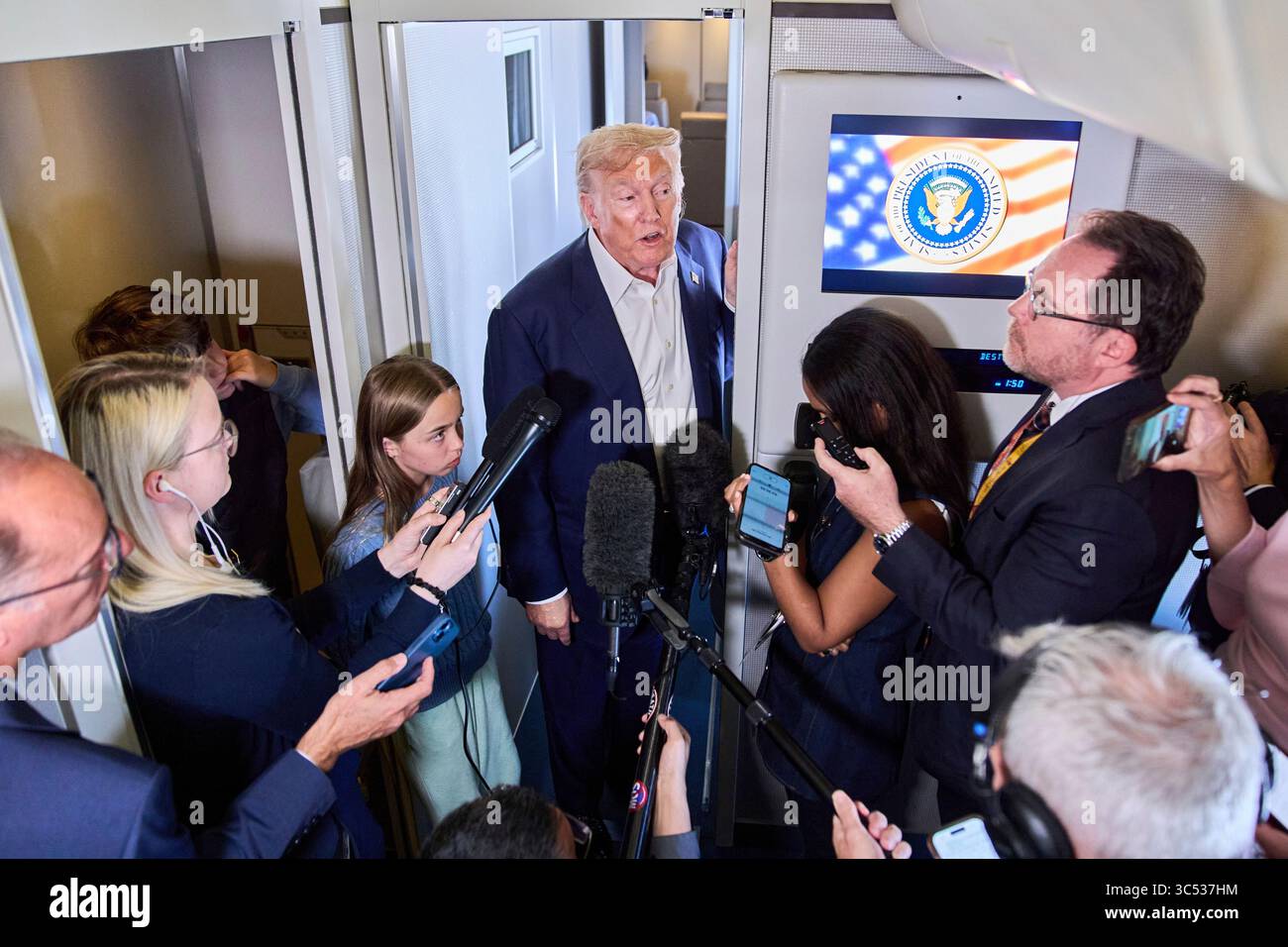 President Donald Trump speaks with reporters aboard Air Force One after ...