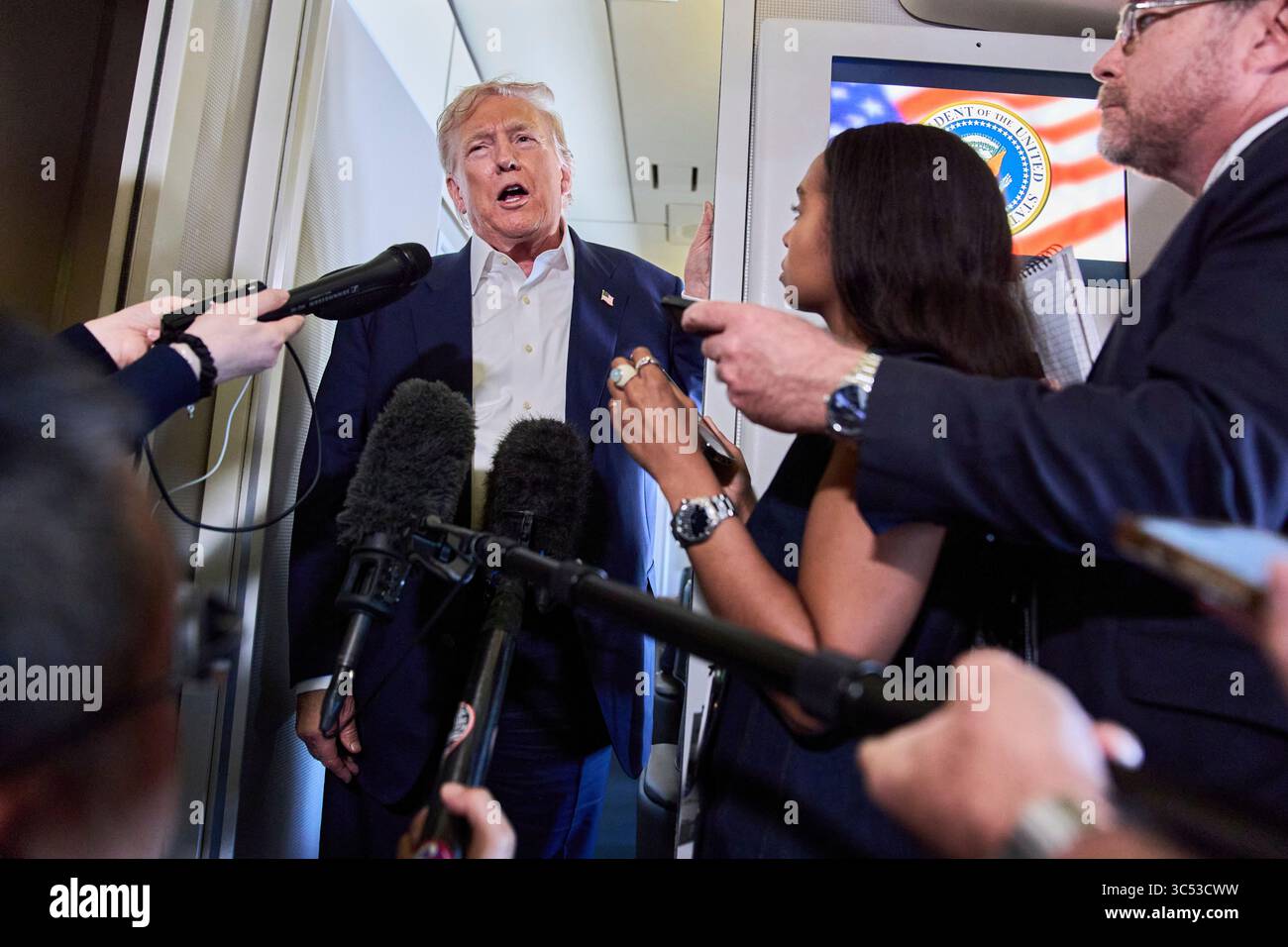 President Donald Trump speaks with reporters aboard Air Force One after ...