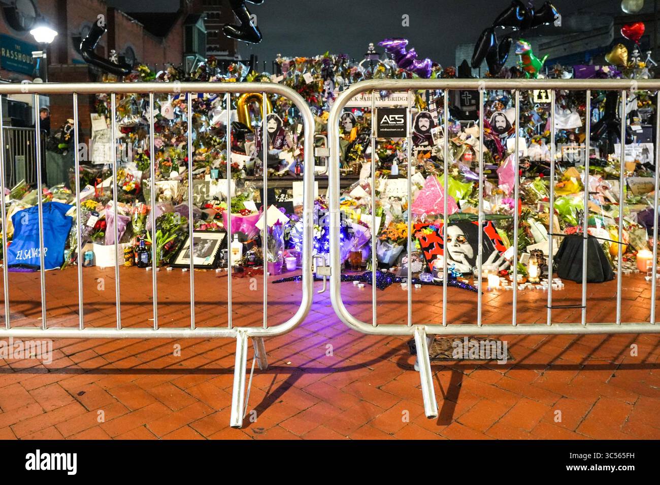 Broad Street, Birmingham 30th July 2025: A sea of floral tributes to Ozzy Osbourne have now been barricaded off at the shrine on Black Sabbath Bridge on Broad Street in Birmingham before Ozzy Osbourne's funeral cortege is expected to stop here at 1pm on Wednesday 30 July. The fence is to allow the Osbourne family to stop and read messages left by his fans since his death. Credit: British News and Media/Alamy Live News Stock Photo