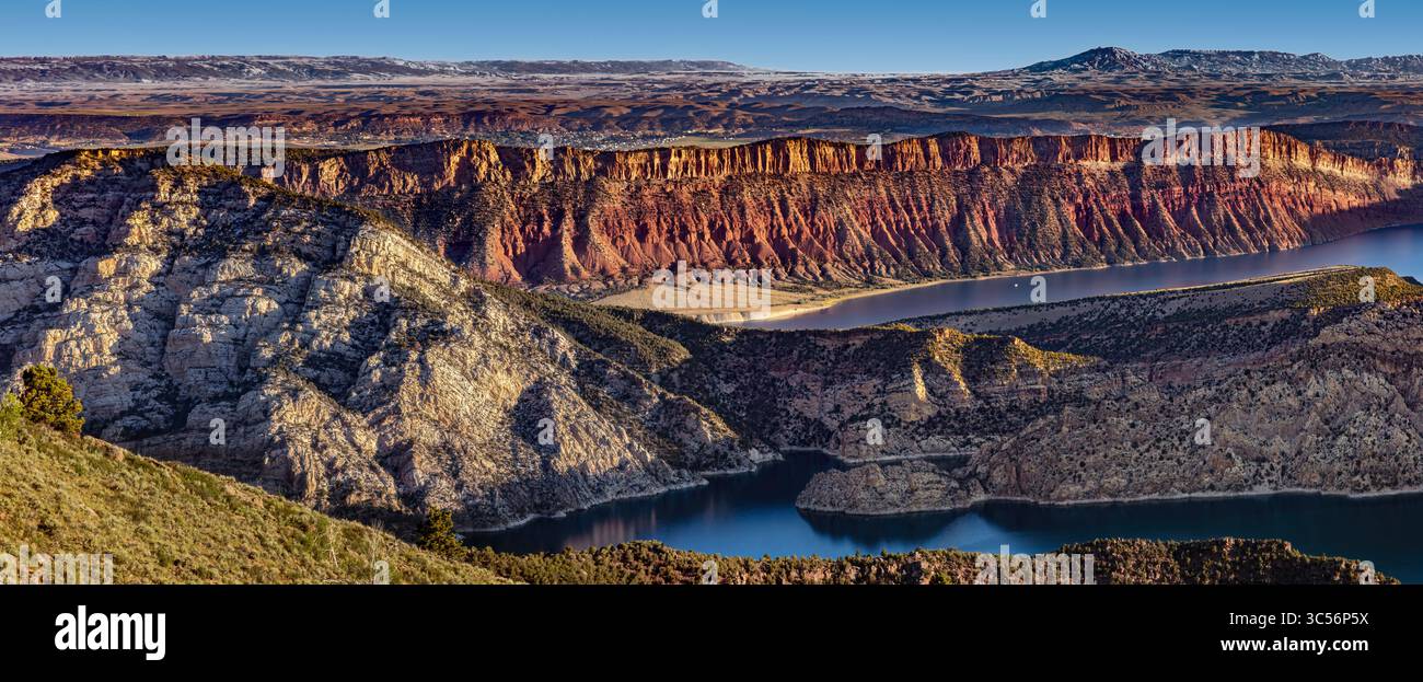 Vividly Banded Sedimentary Rock rises above the Blue Waters of Flaming ...