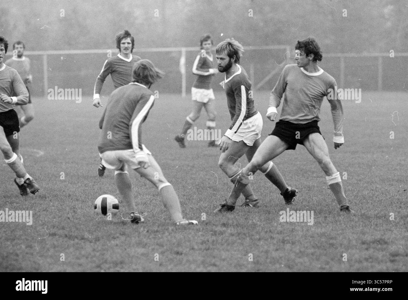 Energy - Young Hercules, Football, 29-10-1977 Whizgle News, Dutch Desk, The Netherlands, 1950-2000 A group of soccer players engage in an intense match on a grassy field, showcasing their agility and teamwork as they maneuver the ball while dressed in vintage athletic gear. The atmosphere is filled with energy as players concentrate on the game. Stock Photo