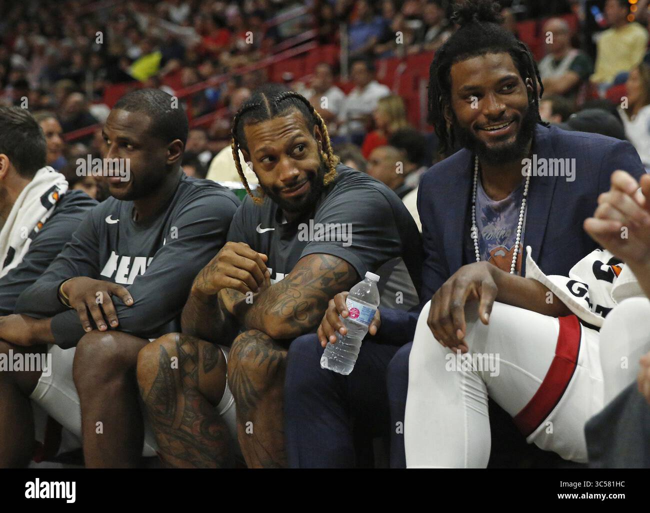 Toronto Raptors players look on from the sideline during the final seconds  of the second half of an NBA basketball game against the Miami Heat,  Saturday, April 11, 2015, in Miami. The, image size:1300x1026