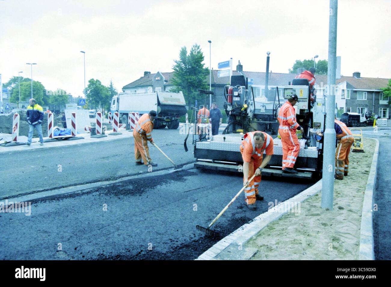 Construction workers in orange uniforms hi-res stock photography and ...