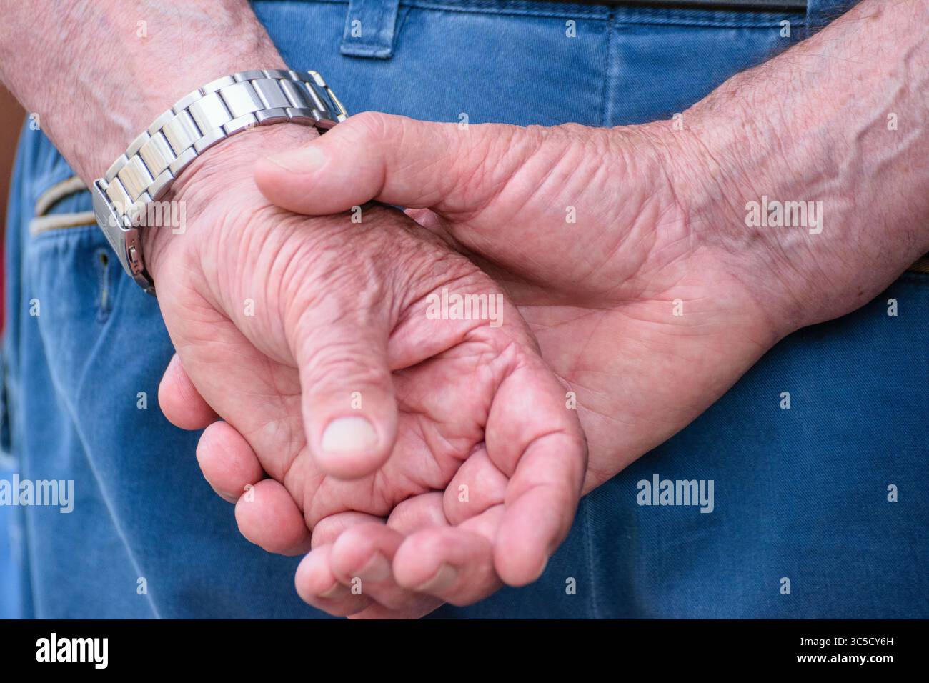 Old man hands behind back hi-res stock photography and images - Alamy