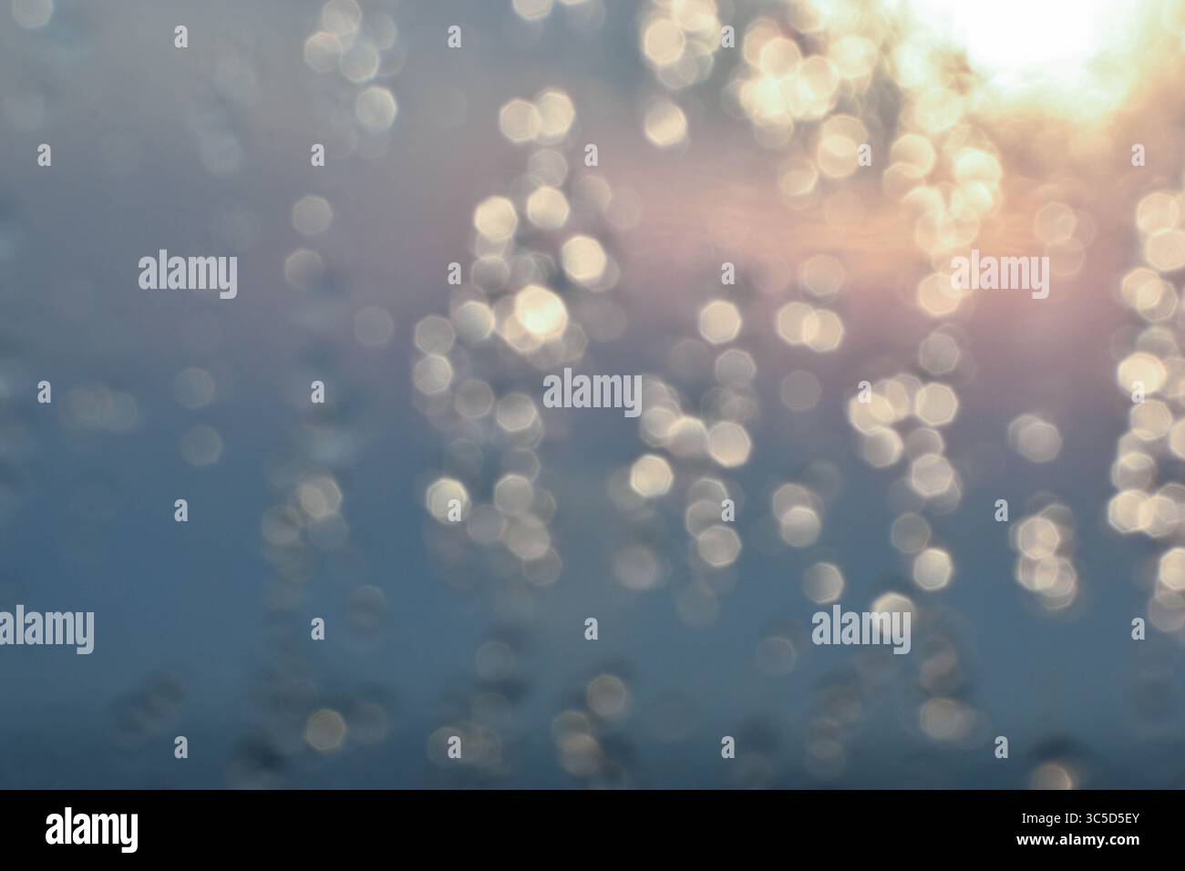 Golden light refracts through water, creating a mesmerizing abstract pattern. Stock Photo