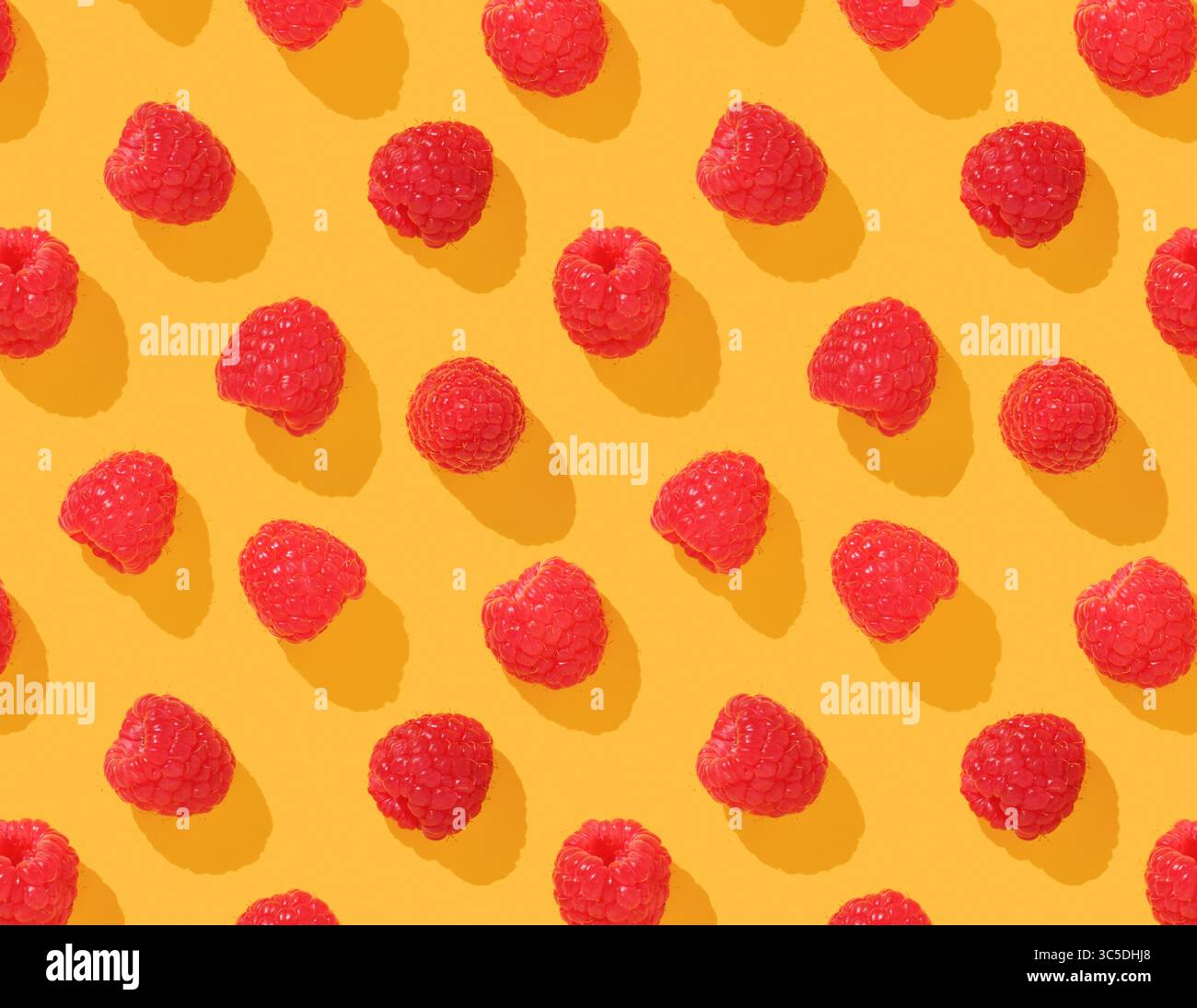 Pattern with raspberries on yellow background Stock Photo