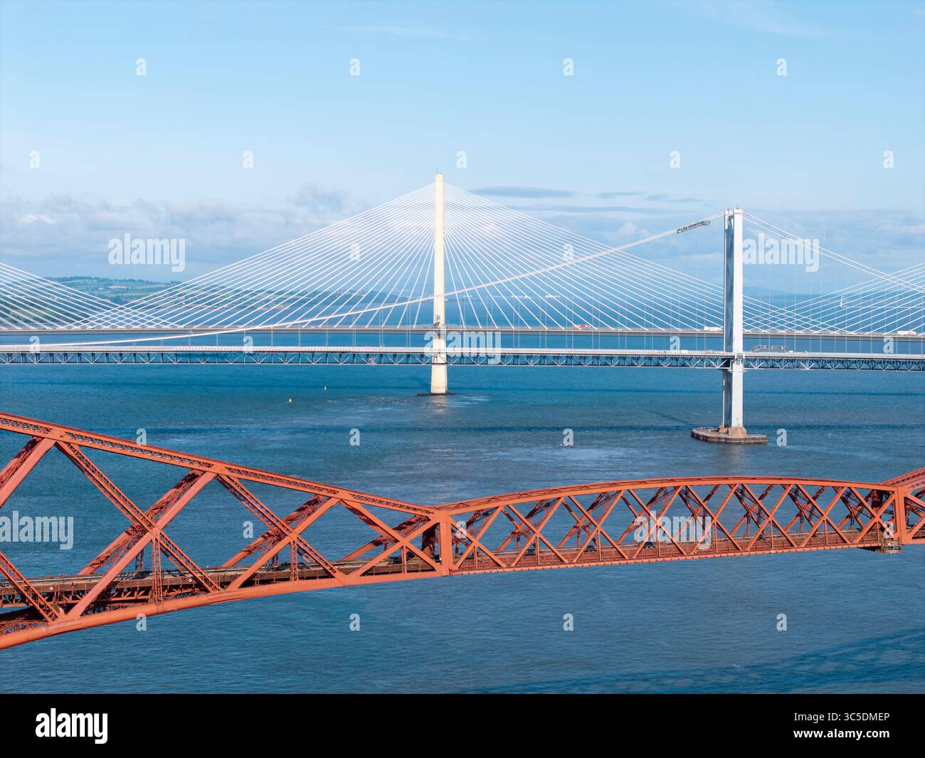 NORTH QUEENSFERRY, FIFE, SCOTLAND - JUNE 18, 2025: Aerial view captures the Forth Rail Bridge spanning the Firth of Forth near North Queensferry, Scot Stock Photo