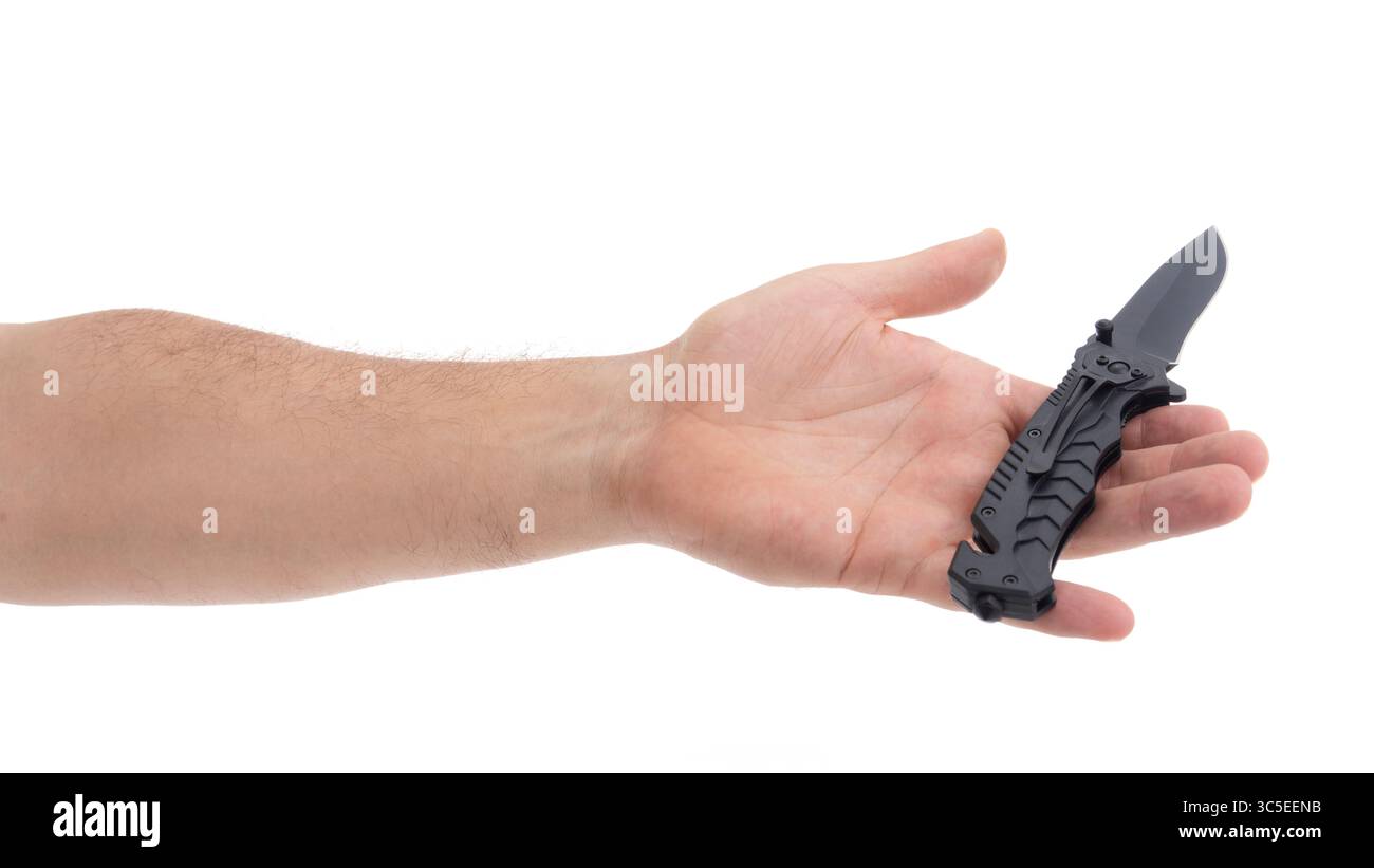 Hand holds a black folding knife in studio light Stock Photo